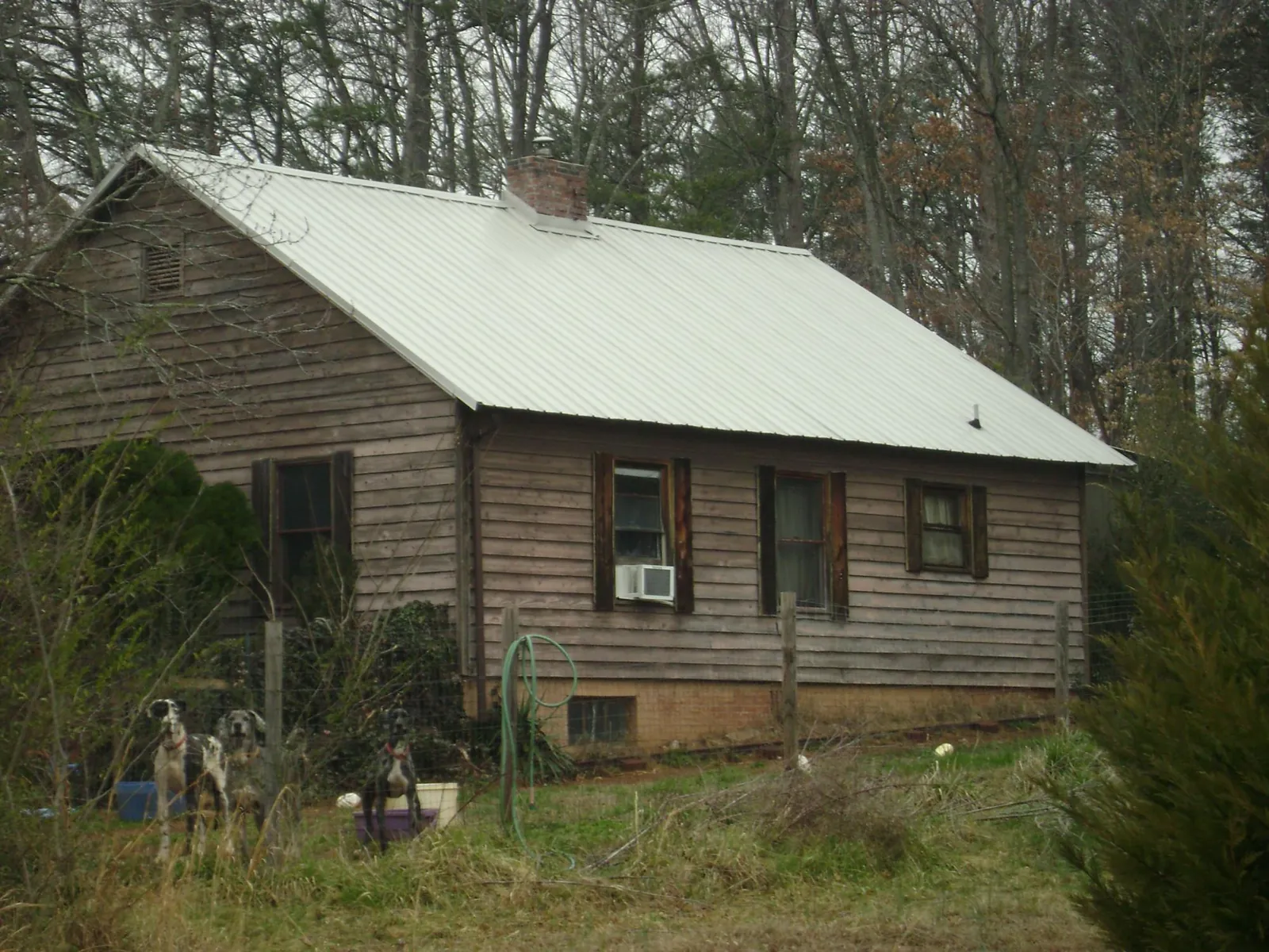White metal roof on an old wood sided farmhouse, from a Metal Roof Installation job in South Pittsburg